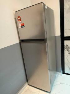 a stainless steel refrigerator in the corner of a room at Live Like Your Home, Alma Bukit Mertajam in Bukit Mertajam