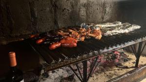 a grill with meat and other food on it at Tribal house in Río Seco