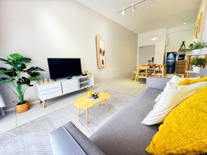 a living room with a couch and a tv at Decozy 9 Ipoh Town Condo 12pax in Ipoh