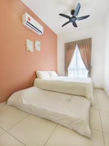 a bedroom with two beds and a ceiling fan at Decozy 9 Ipoh Town Condo 12pax in Ipoh