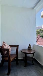 a bench and a table and a chair in a room at Ellenbrook Rooms 17 by Mulia Cottage in Seminyak