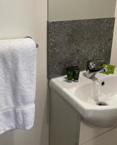 a bathroom with a sink and a white towel at Bacchus Marsh Caravan Park in Bacchus Marsh +12 photos