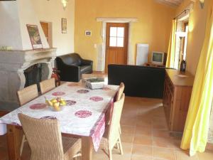 a dining room with a table with a bowl of fruit on it at Stylish villa with swimming pool in Fraissé-des-Corbières