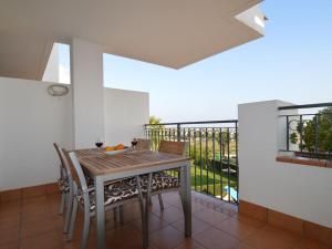 a dining room with a table and chairs and a balcony at Lovely Apartment in Valencia near Sea in Los Dolses