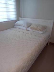 Rúm í herbergi á Urban Oasis 2BR Condo with Multiple Pools at SMDC Charm Residences