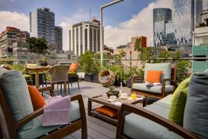 墨西哥城Reforma Guest House的带家具的阳台,享有城市美景