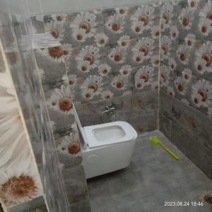 a bathroom with a urinal in a wall at Hotel Harihar Atithi Bhawan in Naimishāranya