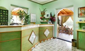 a kitchen with a large mirror and a large window at Hotel Residence Mendolita in Lipari