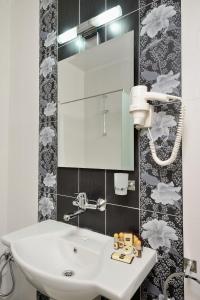 a bathroom with a white sink and a mirror at Villa Paris in Hisarya