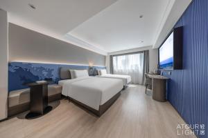 Postel nebo postele na pokoji v ubytování Atour Light Hotel Kunming Dongfeng Plaza Beijing Road