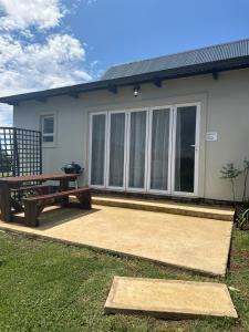 a house with a picnic table and a bench at Breathtaking Midlands stay at THE PROTEA CHALET 5kms from N3 in Hilton +16 photos
