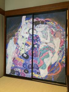 a painting of a woman in a dress at 小グループ専門貸切一軒家 パーティーOK観光スポット徒歩圏内 小諸駅歩2分揚羽屋 Specializing in small groups, Party OK, Walking to tourist spots, Vacation Rental House 2 min from Komoro sta in Komoro