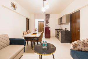 a living room with a couch and a table at The Orion Premium Suites in Mumbai