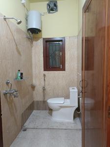 a bathroom with a toilet and a sink at 'Nijor Homestay' Your own Charming & Relaxing 1BHK in Dispur
