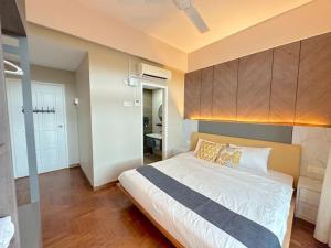 a bedroom with a large bed and a bathroom at Century Suria Seaview + 3 Bedroom Apartment in Kuah +19 photos