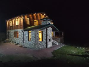 a stone house at night with lights on it at The River View Villa الحلال Halal Concept in Quba