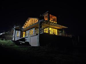 a house at night with the lights on at The River View Villa الحلال Halal Concept in Quba