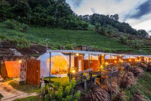 a row of domed tents on a hill at night at เอนจอยดอยแจ่ม in Ban Thung Pa Haeo