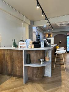 a coffee shop with a counter and a table at Have a SMOOTH day in Kanchanaburi City
