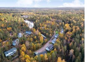 an aerial view of a forest with a group of rvs at Huvila saunalla ja paljulla Korpilammen rannalla in Espoo