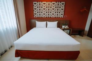 Postel nebo postele na pokoji v ubytování Praja Hotel