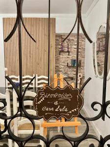a sign on a table in a room with chairs at Casa LuLa in Villafranca de Córdoba