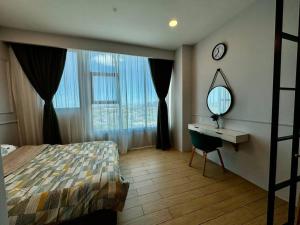a bedroom with a bed and a desk and a mirror at Manhattan Suites ITCC by KinabaluKomfortHomestay - Eloise in Donggongon