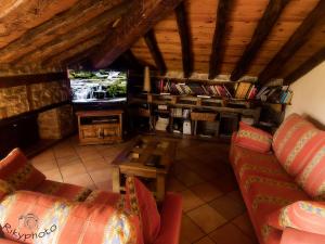 ein Wohnzimmer mit einem Sofa und einem TV in der Unterkunft Posada Corral Mayor in La Serna
