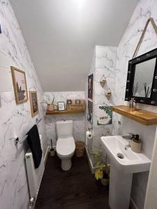 a bathroom with a toilet and a sink at Valentinos in Bollington