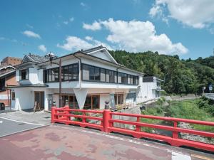 a house with a red fence in front of it at 三笠館Mikasakan 本館 in Kinokawa +45 photos