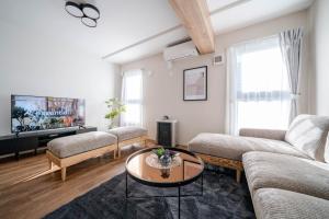 a living room with a couch and a table at Zabo Hills 203 in Sapporo +118 photos