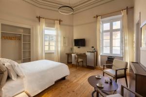 a bedroom with a bed and a desk and a television at 6 Roosevelt Str in Ermoupoli