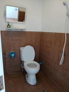 a bathroom with a toilet and a mirror and a shower at Ao Yai Homestay Koh Kood in Ko Kood