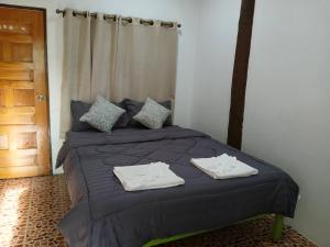 a bedroom with a bed with two towels on it at Ao Yai Homestay Koh Kood in Ko Kood