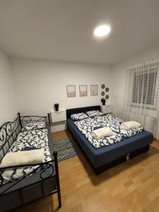 two beds sitting in a room with at Blue harmony SB in Slavonski Brod