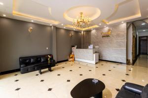 a living room with a chandelier and a fireplace at Hawaii Hotel Dalat in Da Lat