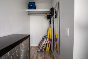 a bunch of skis are hanging in a room at Spacious 2 Bedroom, 1 bath Waikiki Condo in Honolulu