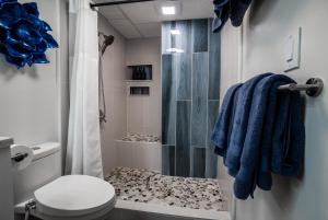 a bathroom with a shower and a toilet at Spacious 2 Bedroom, 1 bath Waikiki Condo in Honolulu +33 photos