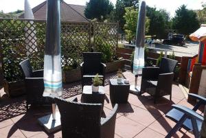 a group of chairs and umbrellas on a patio at Kiebitzei in Wittdün