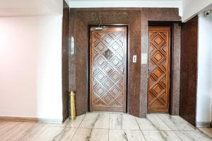 an entrance to a building with a wooden door at FabHotel Darshan Tower in Nagpur +22 photos