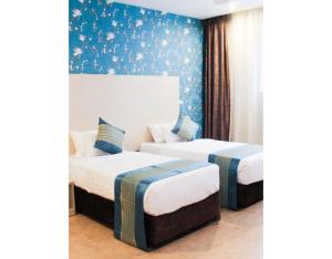 Postel nebo postele na pokoji v ubytování Blooming Suites