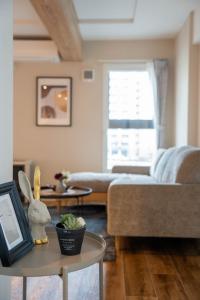 a living room with a couch and a table at Zabo Hills 303 in Sapporo +121 photos