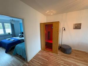 a bedroom with a bed and a door to a room at Ferienwohnung NORDLICHT mit Balkon und Smart-TV in Rostock