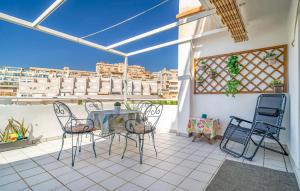 a patio with a table and chairs on a balcony at Pet Friendly Apartment In Aguadulce in Aguadulce +11 photos