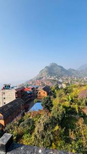 a view of a city with a mountain in the background at Bandipur Pradhan Homestay in Bandipur +10 photos