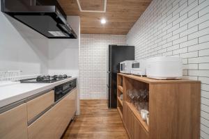 a kitchen with a stove and a refrigerator at Zabo Hills 305 in Sapporo