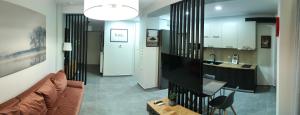 a living room with a couch and a kitchen at Thess - In Toumpa in Thessaloniki