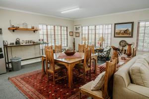 a living room with a table and chairs at Filmerton Country Lodge in Kyalami