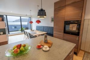 a kitchen with a bowl of fruit on a counter at Town house with good view on top of Tromsø Island in Tromsø
