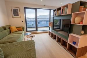 a living room with a couch and a large window at Town house with good view on top of Tromsø Island in Tromsø